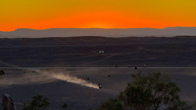 Voyage moto au Maroc MM8 – Coucher de soleil sur les dunes Coucher de soleil dans le Sahara, avec de longues ombres et des dunes de sable baignées d'une lumière chaleureuse